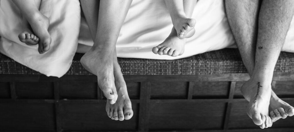 family chilling on the bed