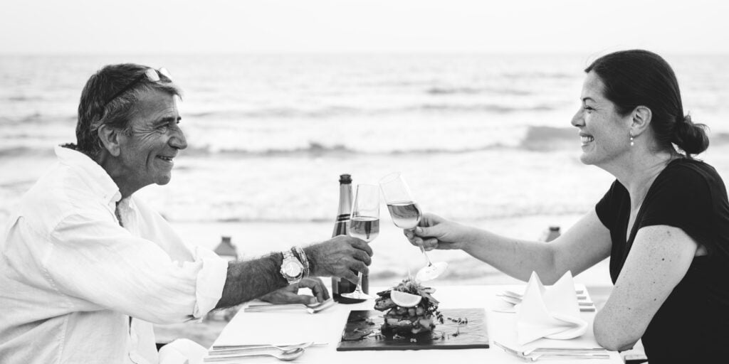 a couple toasting on the beach